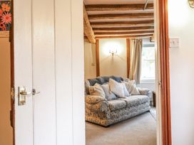 A living room with a sofa and cushions at White Gates in Banham