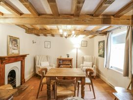 A sitting room with a wooden table and chairs at White Gates in Banham