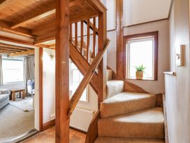 A staircase with wooden railing and a window at White Gates in Banham