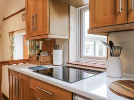 A kitchen with a countertop and window at White Gates in Banham