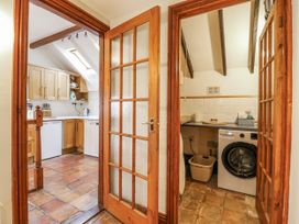 A laundry room with a washing machine and countertops at White Gates in Banham