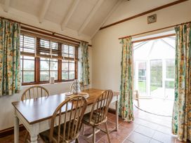 A dining room with a table and chairs at White Gates in Banham