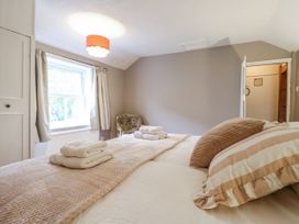 A bedroom with a bed and window at White Gates in Banham
