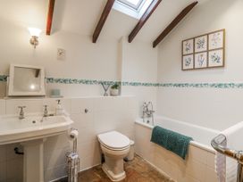 A bathroom with a bathtub, sink, and toilet at White Gates in Banham