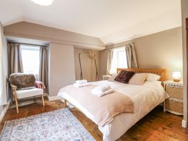 A bedroom with a bed and bedside table at White Gates in Banham