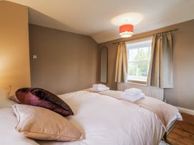 A bedroom with bed and towels on the bed at White Gates in Banham