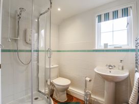 A bathroom featuring a shower, toilet, and sink at White Gates in Banham