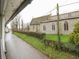 A view of a church and road from a window at White Gates in Banham