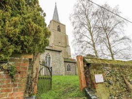 A church building behind a gate at White Gates in Banham