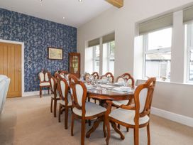 A dining room with a wooden table and chairs at The Gatehouse