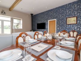 A dining room with a wooden table and chairs at The Gatehouse
