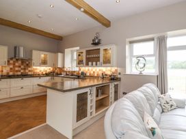 A kitchen with cabinets and a countertop at The Gatehouse