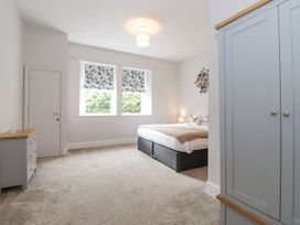 A bedroom with a bed and wardrobe at The Gatehouse