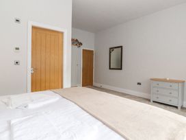 A bedroom with a bed and dressing table at The Gatehouse in 