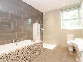 A bathroom with a shower and bathtub at The Gatehouse in 