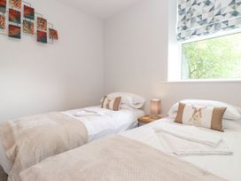 A bedroom with two beds and wall art at The Gatehouse