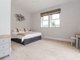 A bedroom with a bed and desk at The Gatehouse