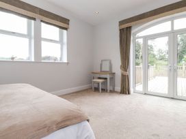 A bedroom with a bed and a table at The Gatehouse
