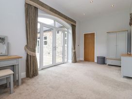 A living room with a door and table at The Gatehouse