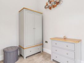 A bedroom with a wardrobe and a chest of drawers at The Gatehouse 