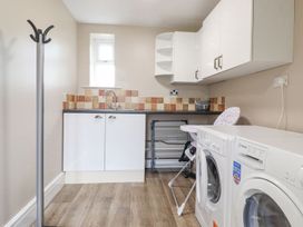 A utility room with a washing machine and dryer at The Gatehouse 