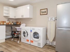 A laundry room with washing machine and dryer at The Gatehouse
