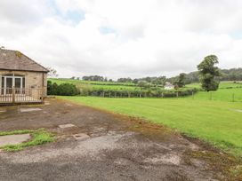 A view of a building with a deck and green landscape at The Gatehouse 