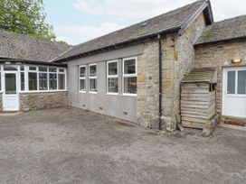 An outdoor area with a garden shed and windows at The Gatehouse in 
