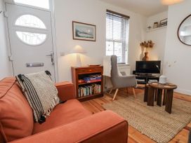 A living room with a sofa and television at Launcher's Cottage in Scarborough