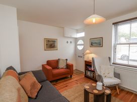 A living room with a sofa and armchair at Launcher's Cottage in Scarborough