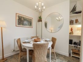 A dining area with a table and chairs at Launcher's Cottage in Scarborough