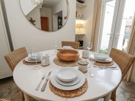 A dining table set with plates and glasses at Launcher's Cottage in Scarborough