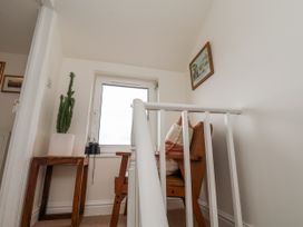 A landing area with a chair and window at Launcher's Cottage in Scarborough
