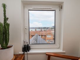 A window with a view and a cactus inside Launcher's Cottage Scarborough