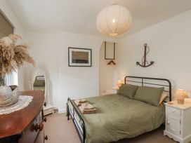 A bedroom with a bed and bedside tables at Launcher's Cottage in Scarborough