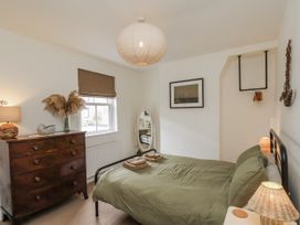 A bedroom with a bed and dresser at Launcher's Cottage in Scarborough