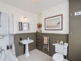 A bathroom with a bathtub and sink at Launcher's Cottage in Scarborough