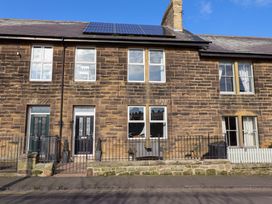 A facade of a building with windows and doors at Dinguardi in Seahouses