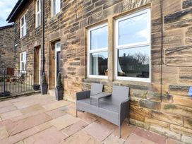 An outdoor area with a patio and seating at Dinguardi in Seahouses