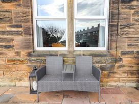 A seating area with a couch and table at Dinguardi Seahouses