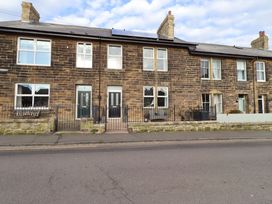 A building with multiple windows and doors at Dinguardi in Seahouses