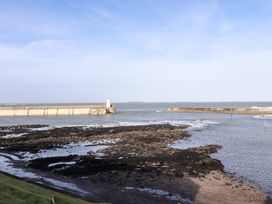 A view of the sea and pier at Dinguardi in Seahouses