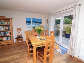 A dining room with a table and chairs at Eydon in Salcombe