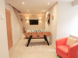A game room with a foosball table and sofa at Eydon in Salcombe