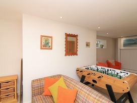 A snug with a foosball table and sofa at Eydon in Salcombe