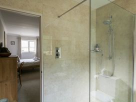 A bathroom featuring a shower and a view of a bedroom at Eydon in Salcombe