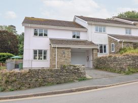 A house with a garage and stone wall at Eydon in Salcombe