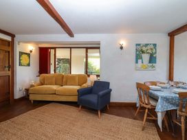 A dining room with a table and chairs at 1 Eastdon Cottages in Exeter