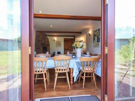 A dining room with a table and chairs at 1 Eastdon Cottages in Exeter