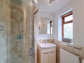 A bathroom with a shower and sink at 1 Eastdon Cottages in Exeter